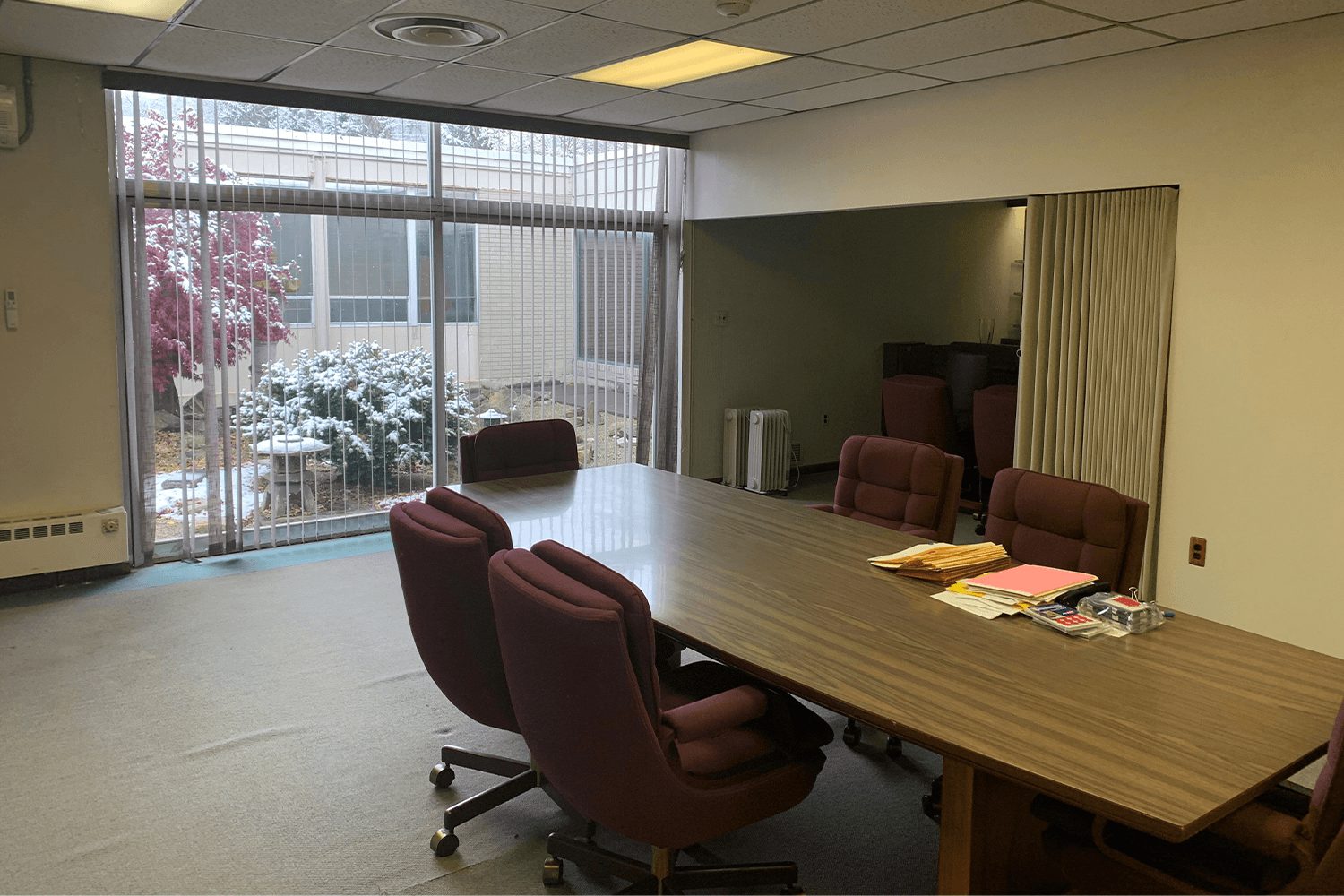 Conference room with a table and chairs and floor-to-ceiling windows