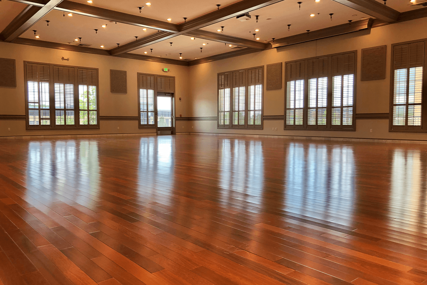 Empty event room with reflective wood floors