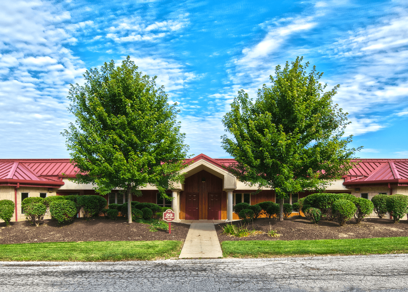 Exterior of a building at Abele Business Park with trees and shrubbery