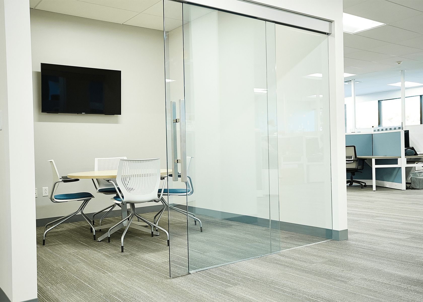 Small collaborative office with glass sliding door