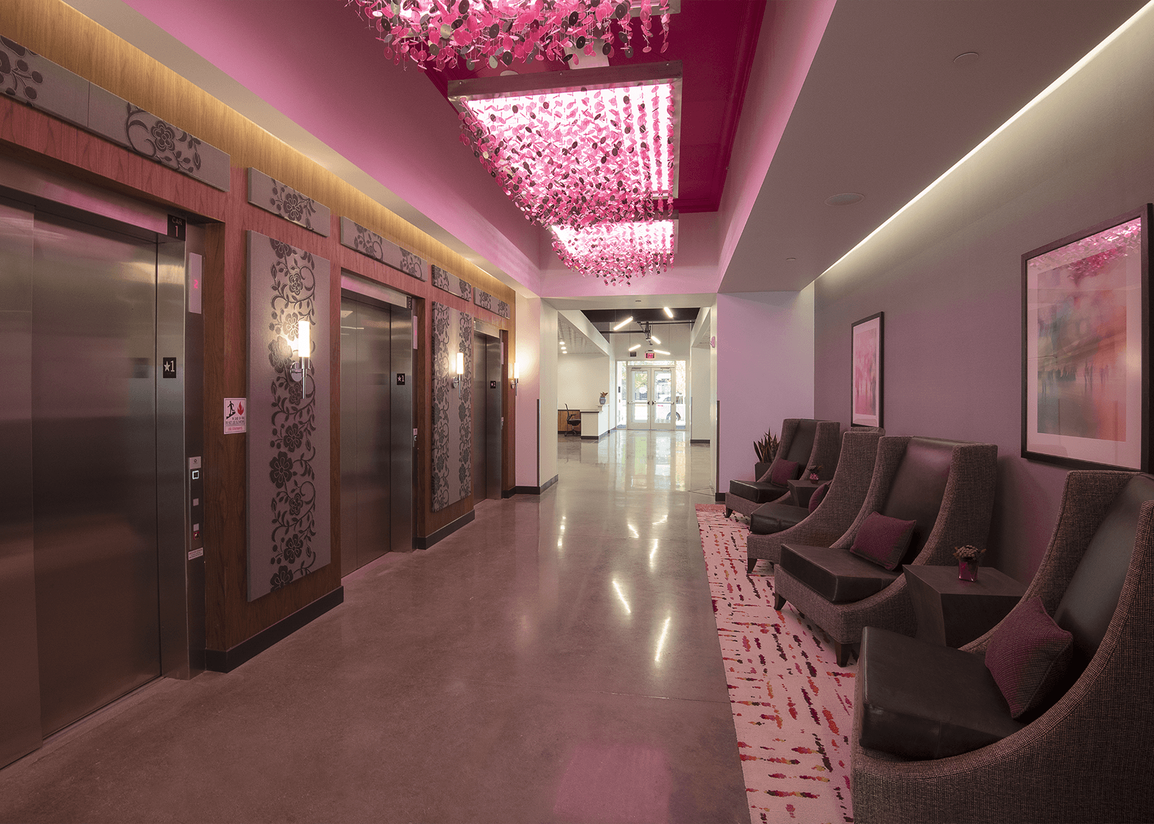 Hallway with chairs and and pink lighting