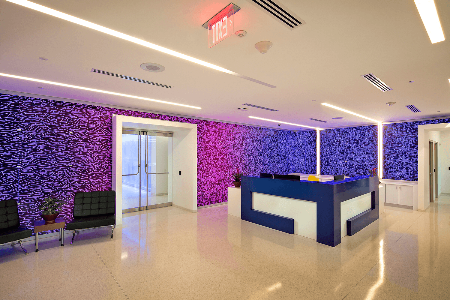reception area with purple and magenta walls with unique patterns