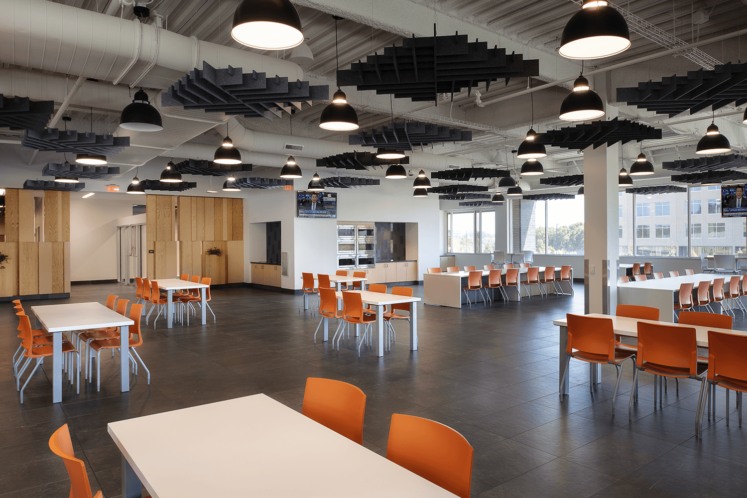 large café with white tables and bright orange chairs
