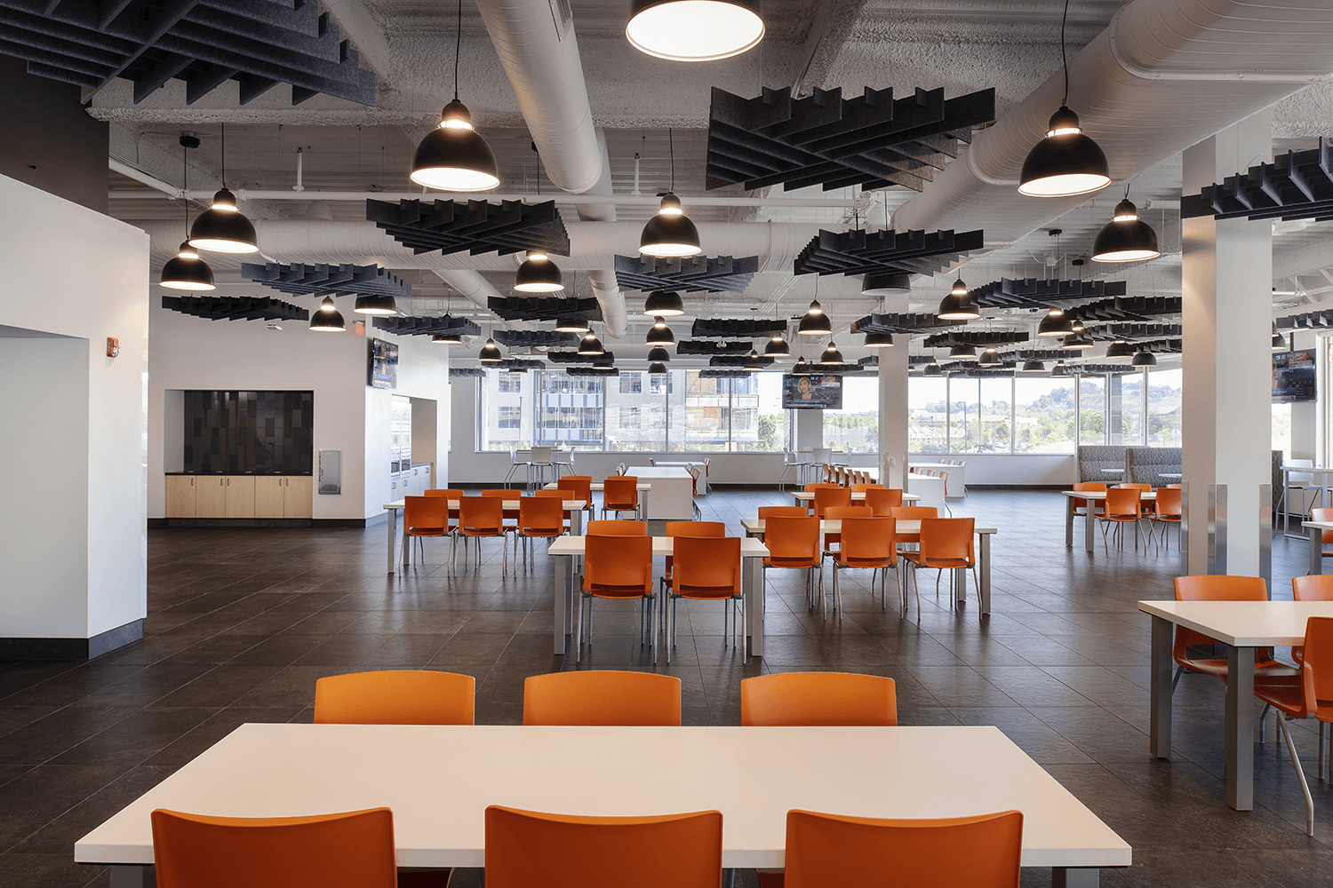large café with white tables and bright orange chairs