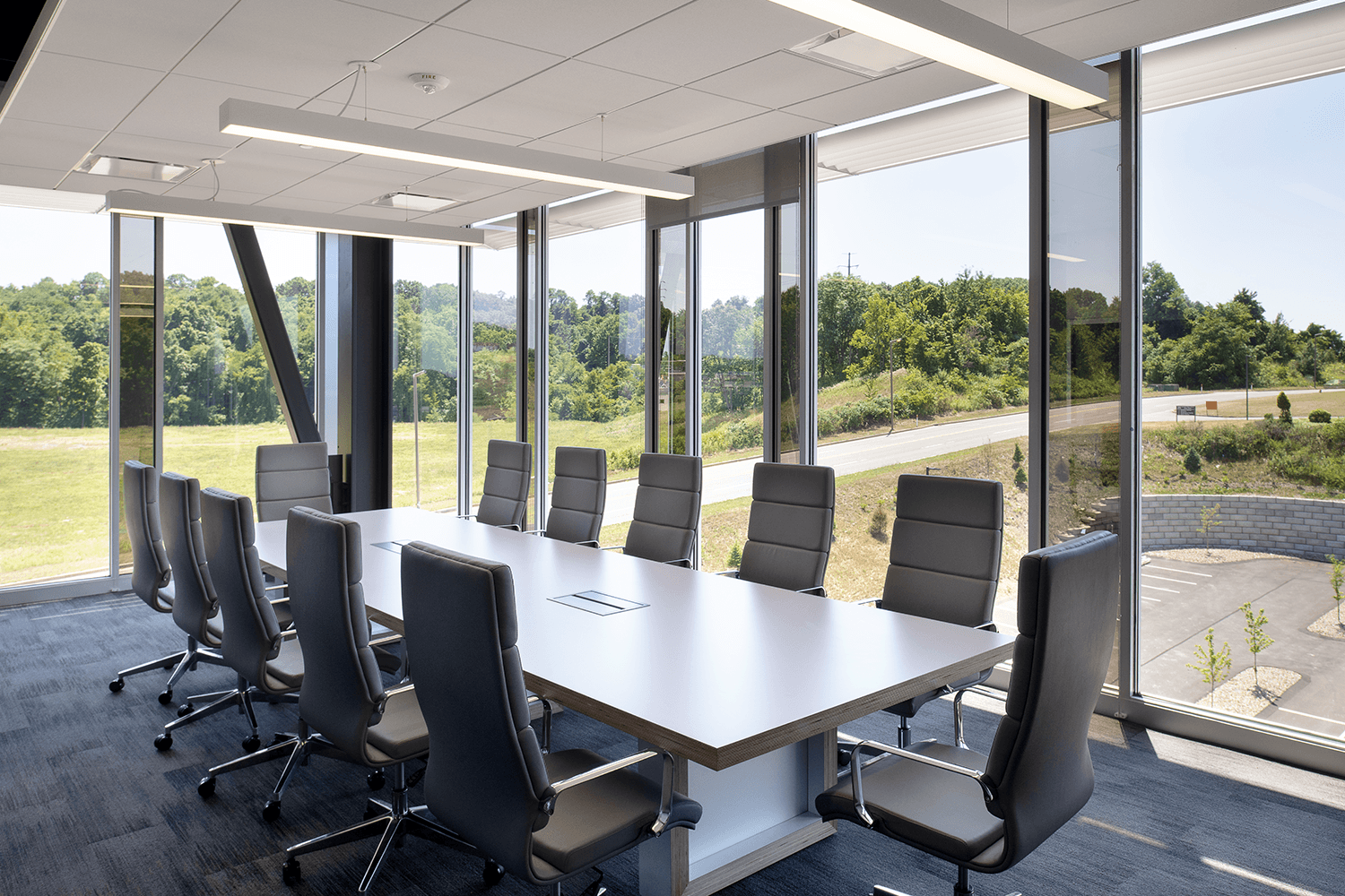 conference room with a table and chairs with large floor-to-ceiling windows