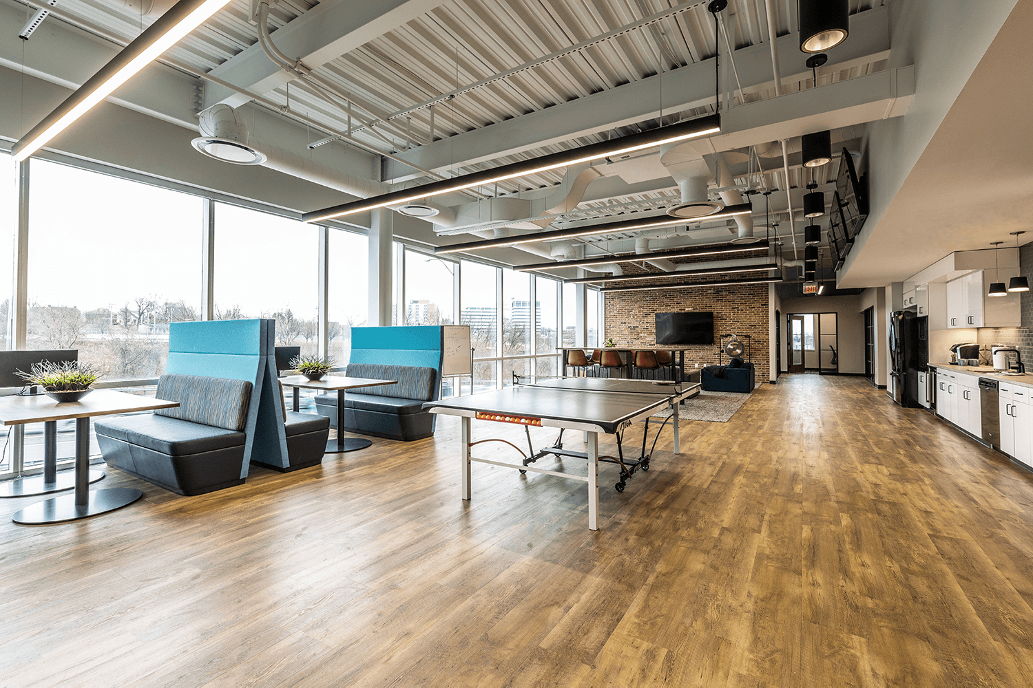 collaborative office space with booths and a ping pong table