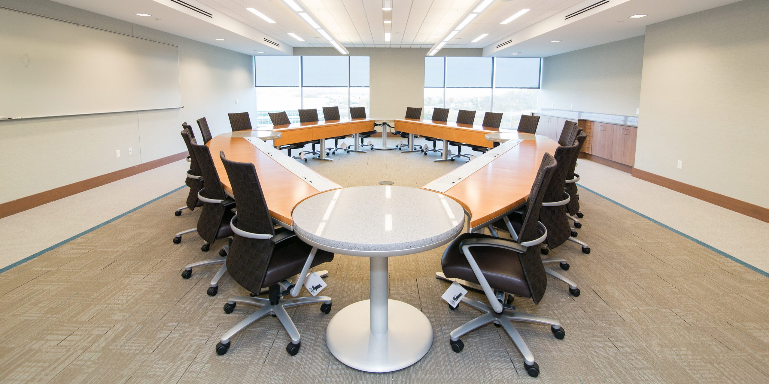 large conference table with many desk chairs around it