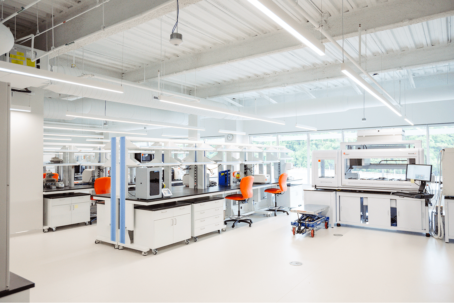bright white lab space with lab equipment and orange chairs