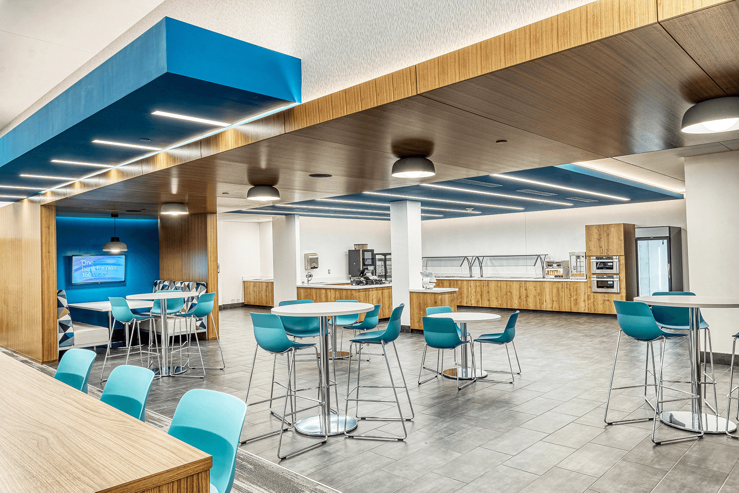 cafeteria with high top tables and turquoise chairs