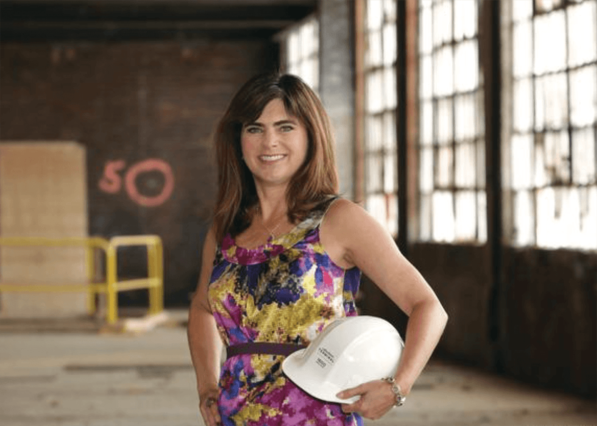 Photo of Pamela Austin holding a construction hard hat