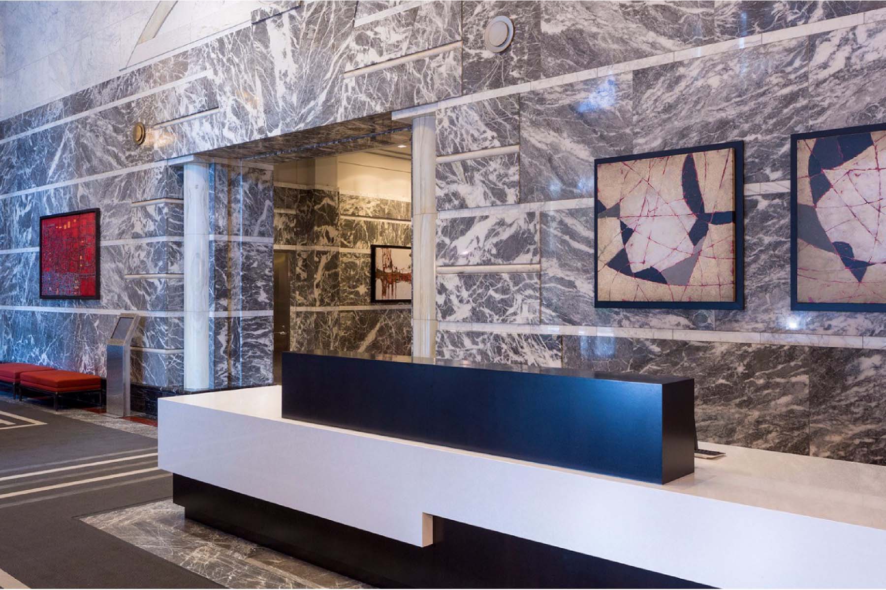 Front desk and lobby area with polished stone walls