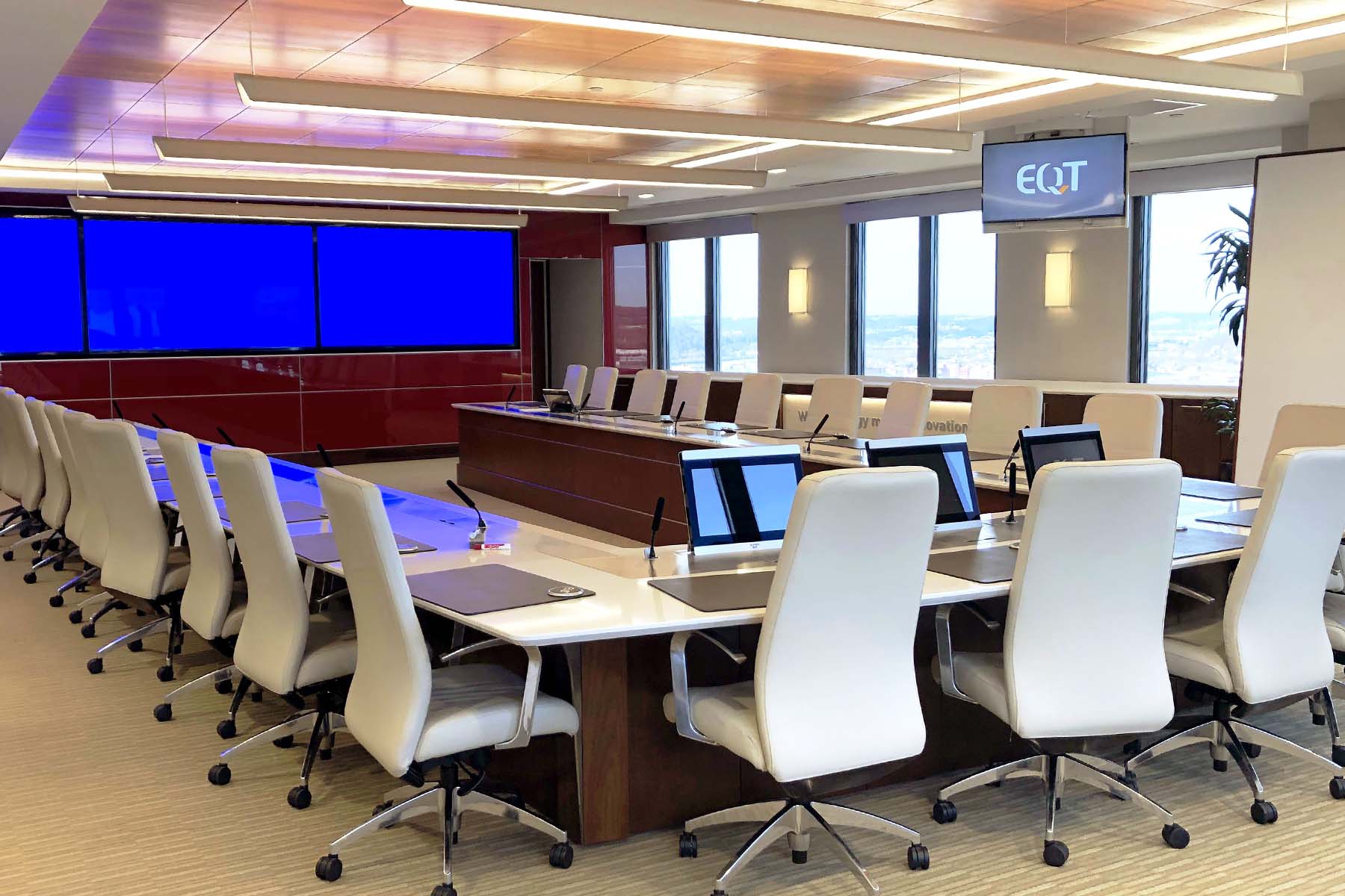 Conference room with TV displays and large U-shaped conference table