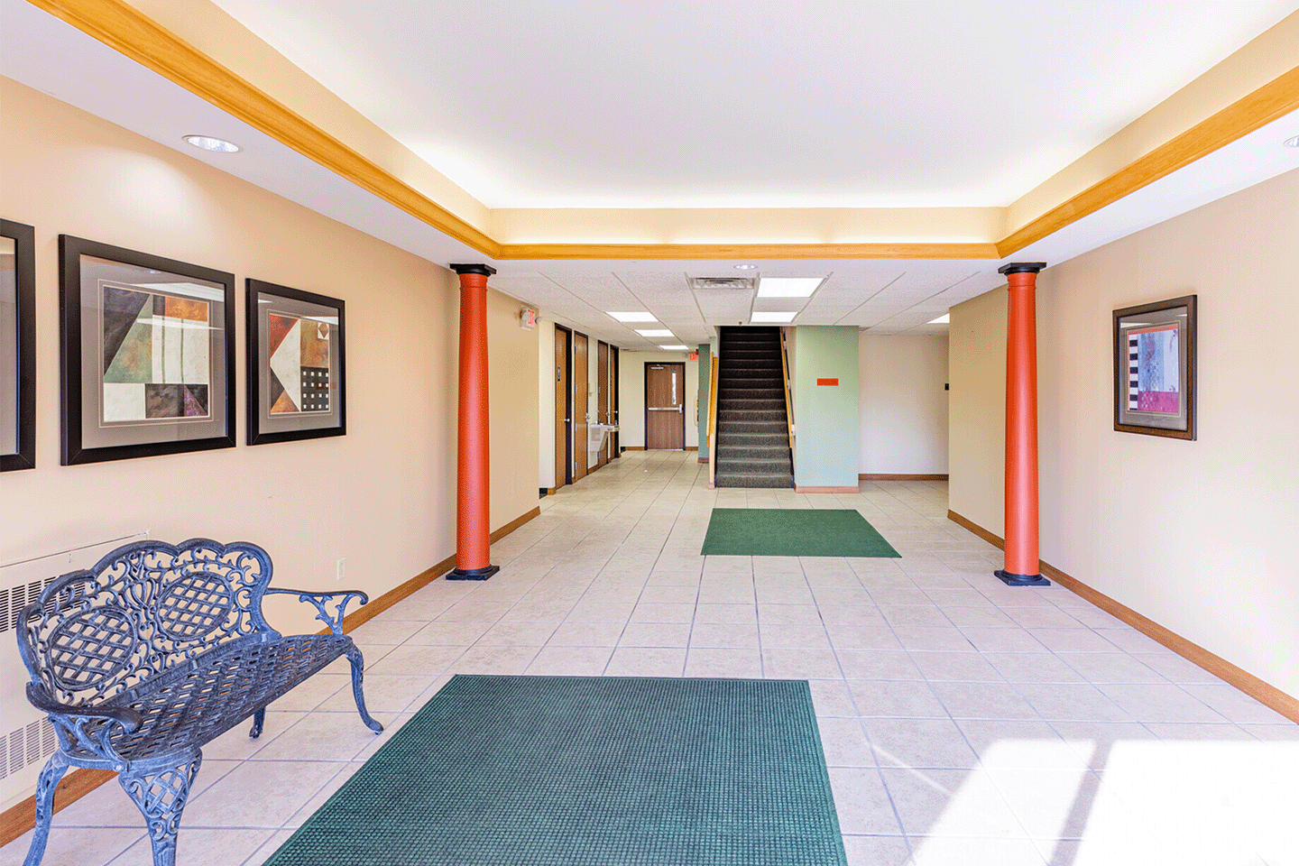 building entry way with long hallway and waiting area with benches