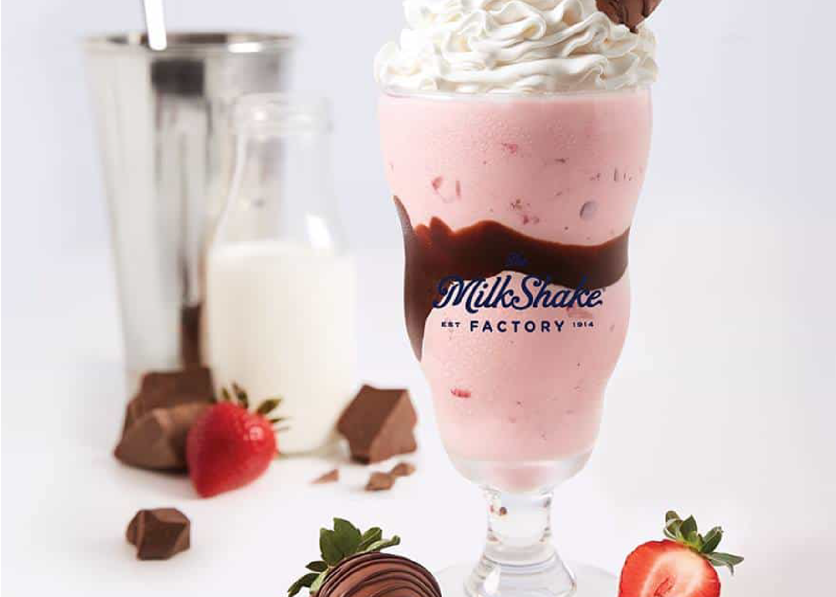 strawberry milkshake with ingredients scattered