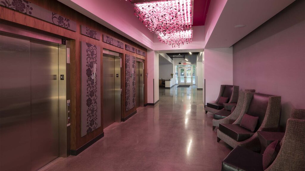 pink lights in a elevator waiting area
